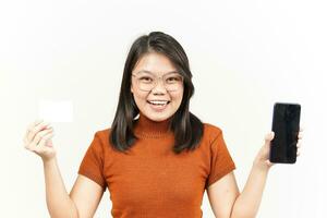 Holding Blank Bank Card and Smartphone With Blank Screen Of Beautiful Asian Woman Isolated On White photo