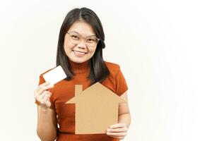 Holding House Cutout And Black Bank Card Of Beautiful Asian Woman Isolated On White Background photo