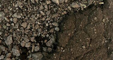 Crushed Stones And Cracked Asphalt Top View Texture photo