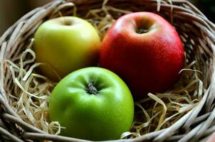 Gala Apple, Granny Smith Apple And Golden Delicious Apple Lie Side By Side In A Wicker Basket photo