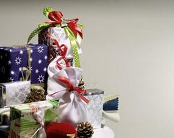 Concept for a greeting card or wallpaper with pile of wrapped gifts on a side of image photo