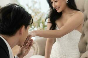 Groom kissing beautiful bride's hand, Love ,Romantic and wedding proposal concept. photo