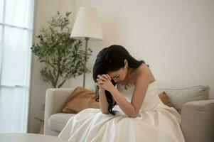 Sad and worried bride crying and arguing with groom in wedding day photo