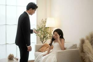 Sad and worried bride crying and arguing with groom in wedding day photo