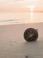 Close up compass on the beach with sunlight photo