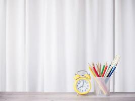 Office desk table, Student creative desktop with colorful stationery and yellow alarm. Copy space for text, Back to school, Education concept photo