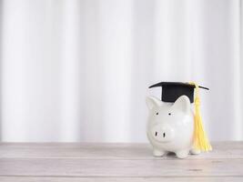 Piggy bank with graduation hat. The concept of saving money for education, student loan, scholarship, tuition fees in future photo