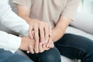 hold hand support each while discussing family issues. doctor encourages and empathy woman suffers depression. psychological, save divorce, Hand in hand together, trust, care photo