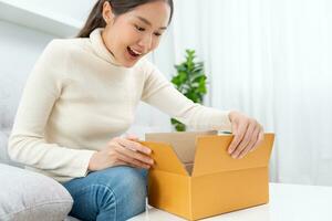 Pretty asian woman feel surprise and look interest inside presents box. cute girl excited open gift box. birthday, Celebration, xmas, New year Festival, thank, Celebrate, Valentine's Day, Anniversary photo