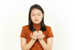 Praying Gesture Of Beautiful Asian Woman Isolated On White Background photo