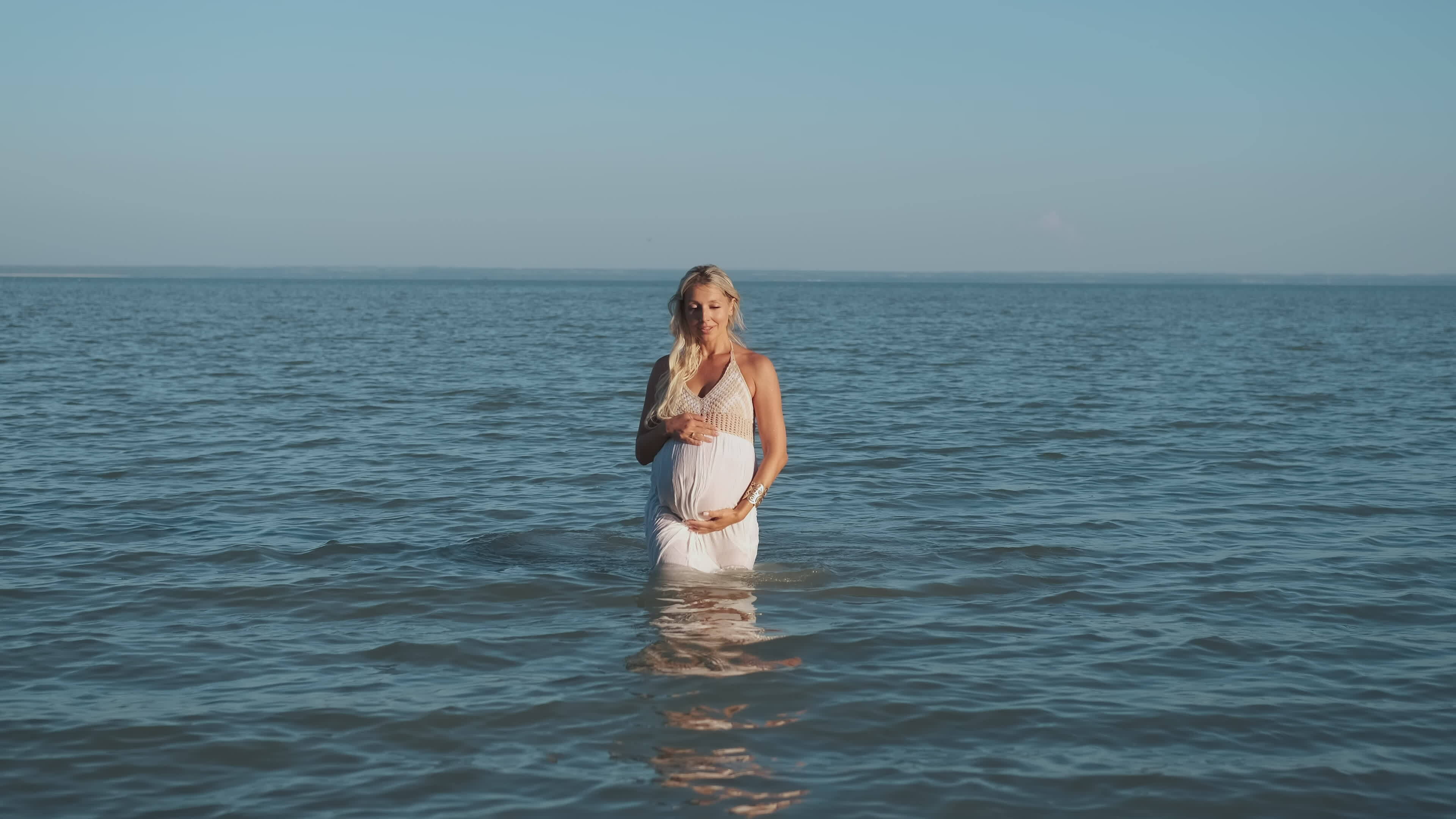 Wet pregnant woman comes out of the water. 35547294 Stock Video at Vecteezy
