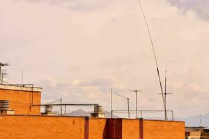 a view of the roof of a building with antennas photo