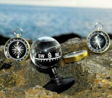 compasses on a rock by the sea photo