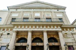 the front of a building with columns photo