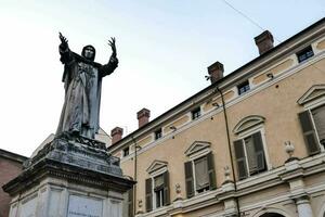 a statue of a woman in front of a building photo