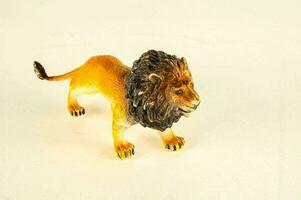 a small figurine of a lion on a white background photo