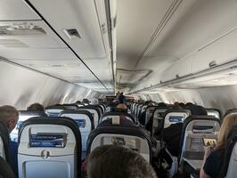 Washington, USA - 12.10.2023 Passengers on an airplane during turbulence in cloudy weather photo