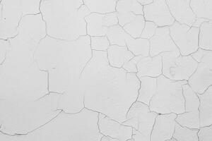 Cracked flaking white paint on the wall, background texture photo