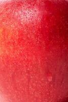 Texture of a red apple as a background. Macro photo of an apple. Healthy food, fruit.