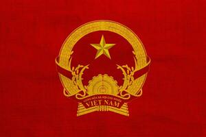 Flag and coat of arms of Socialist Republic of Vietnam on a textured background. Concept collage. photo