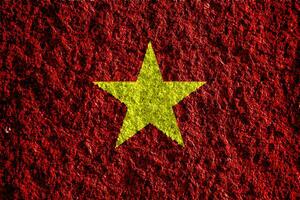 Flag of Socialist Republic of Vietnam on a textured background. Concept collage. photo