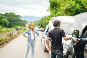 Drivers stood arguing after the car crashed on country road. photo