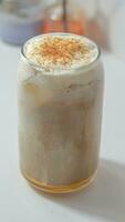 iced coffee latte in a clear glass on a white background photo