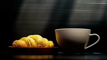 croissant topped with honey with a glass of coffee latte photo