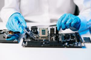 The technician repairing the motherboard in the lab with copy space. the concept of computer hardware, mobile phone, electronic, repairing, upgrade photo