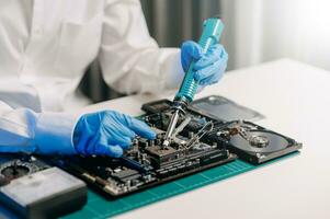 The technician is putting the CPU on the socket of the computer motherboard. electronic engineering electronic repair, electronics measuring and testing, repair photo