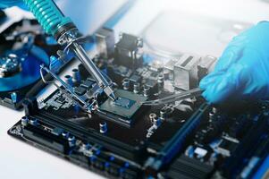 The technician is putting the CPU on the socket of the computer motherboard. electronic engineering electronic repair, electronics measuring and testing, repair photo