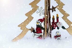 snowman on the Christmas tree and abstract snow fall. Winter holidays concept. photo