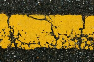 Old yellow traffic lines on the road. photo