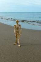 wooden models feel lonely on the beach. photo