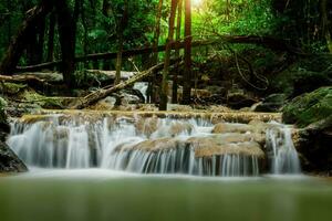 Small waterfall in the forest in summer. photo