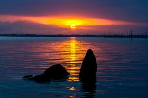 Silhouettes stone and Sunset sky. photo