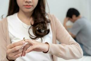 divorcio. la mujer quita el anillo casado. parejas desesperadas y decepcionadas después del matrimonio. esposo esposa triste, molesto y frustrado después de un conflicto de peleas. desconfianza, problemas de amor, traiciones, familia, amante foto