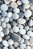 AI generated vertical pebbles texture background, closeup white smooth stones photo