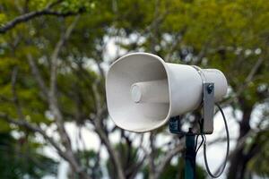 Loudspeakers mounted on steel poles are installed at various points around tourist attractions to promote news to tourists. Soft and selective focus. photo