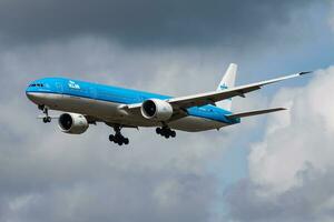 Amsterdam, Netherlands, 2014 - KLM Royal Dutch Airlines Boeing 777-300ER PH-BVI passenger plane arrival and landing at Amsterdam Schipol Airport photo