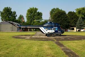 Siofok, Hungary, 2016 - Hungarian government police helicopter at airport and airfield. Rotorcraft. General aviation industry. Police utility transportation. Air transport. Fly and flying. photo