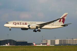 Vienna, Austria, 2018 - Qatar Airways Boeing 787-8 Dreamliner A7-BCA passenger plane arrival and landing at Vienna Airport photo