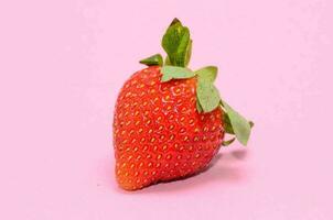 a strawberry on a pink background photo
