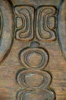 a close up of a carved wooden panel photo