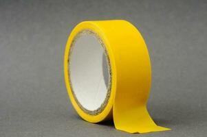 a yellow tape on a grey surface photo