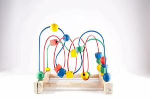 a wooden toy with colorful shapes on a white background photo
