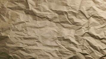 looped spinning closeup fullframe background of crumpled brown craft paper video