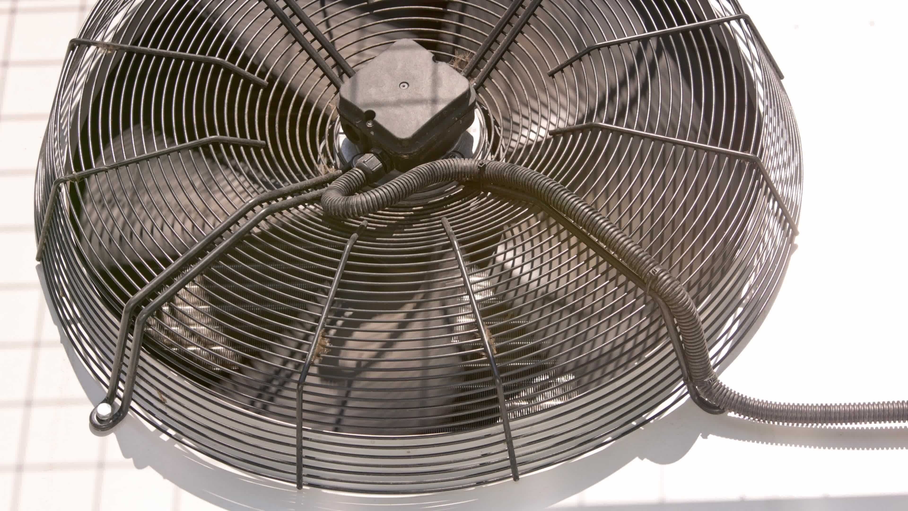 outdoor air conditioner condenser fan spinning, decelerating and ...
