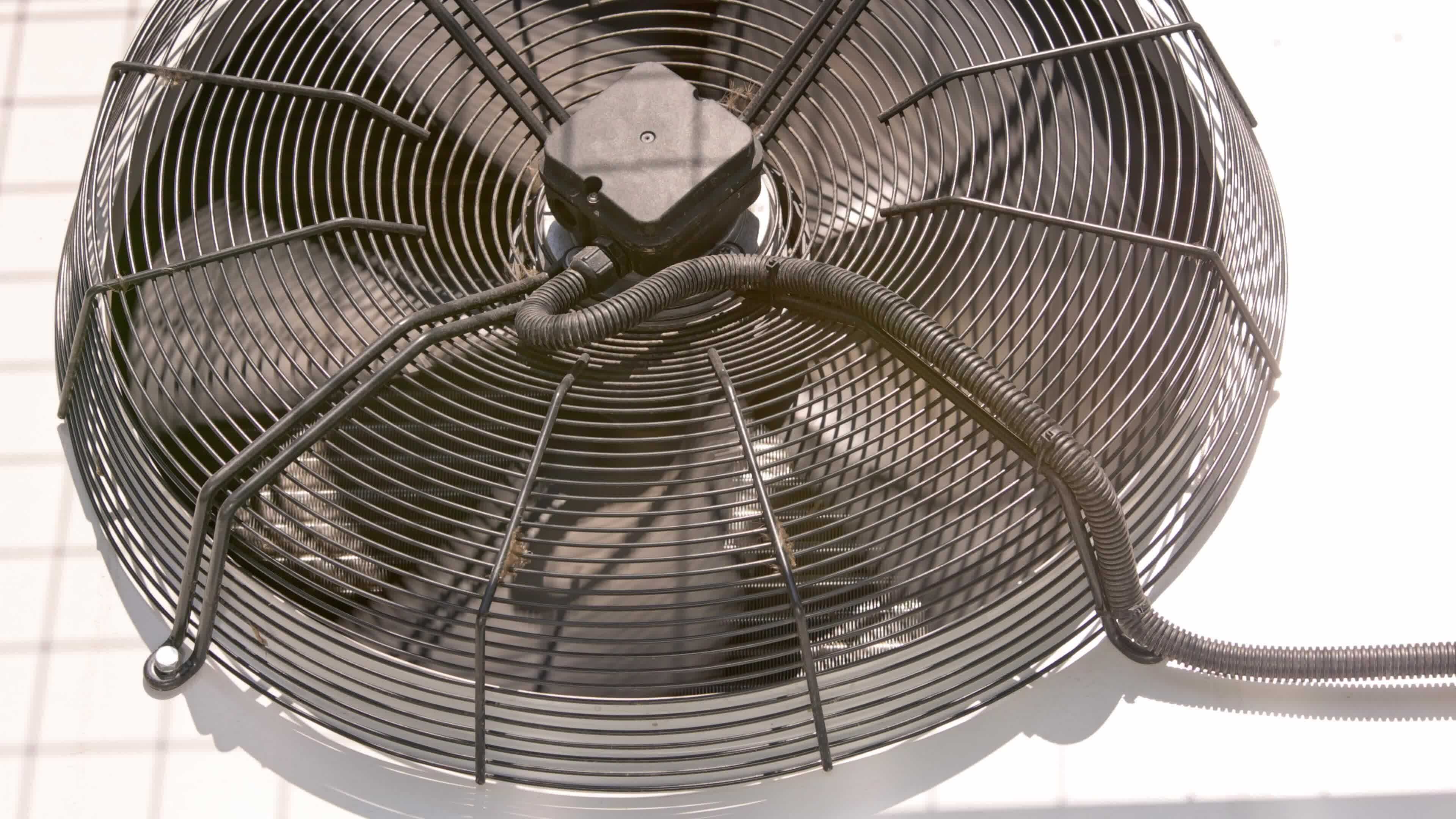 outdoor air conditioner condenser fan spinning, decelerating and