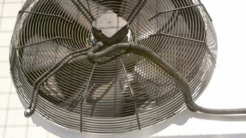 outdoor air conditioner condenser fan spinning, decelerating and accelerating video